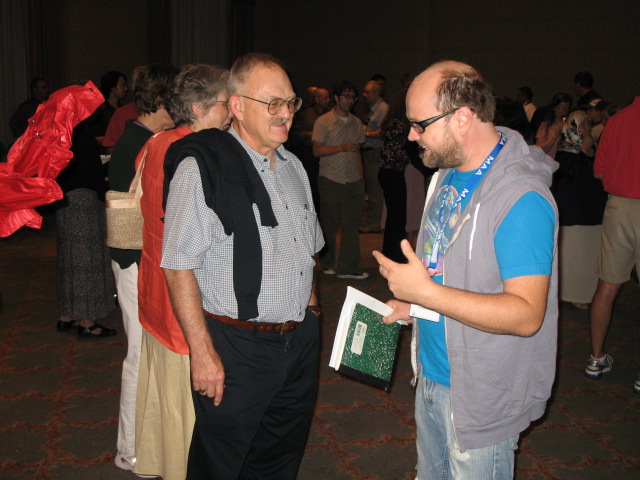 Schneider talks with Jim Tattersall at MAA MathFest 2007.   