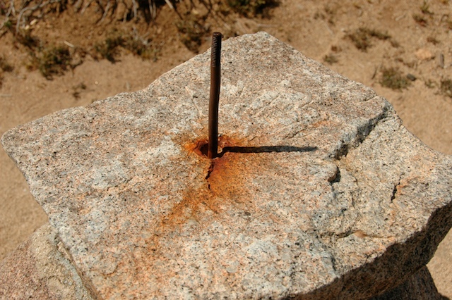 Simple gnomon consisting of vertical stick attached to a rock.